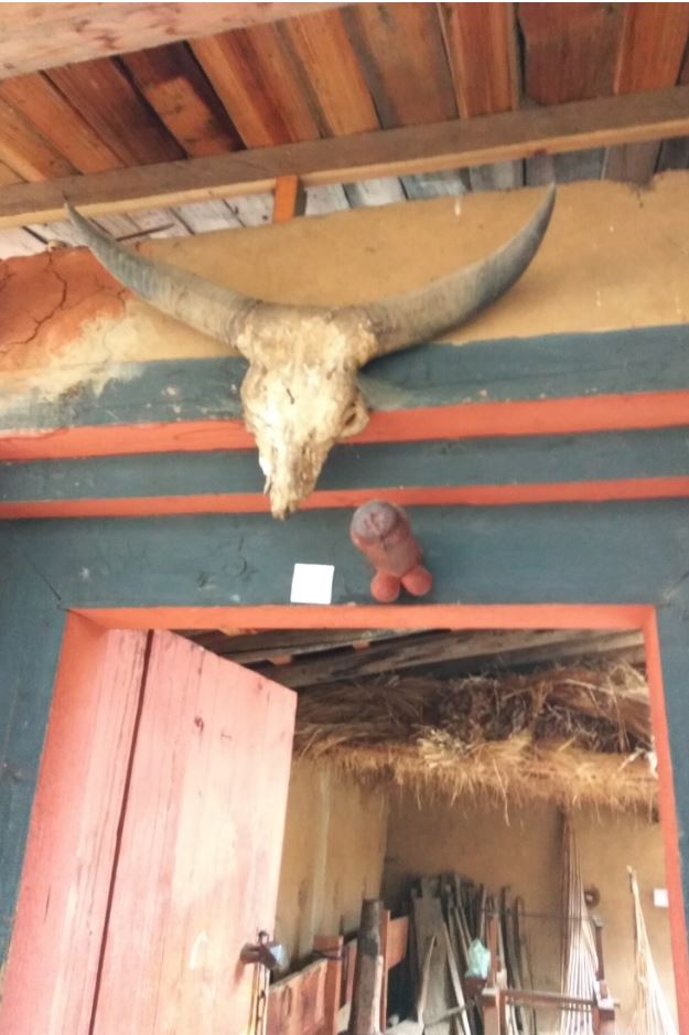 Phallus on top of the main door at the entrance to ward of evil spirits in a traditional house