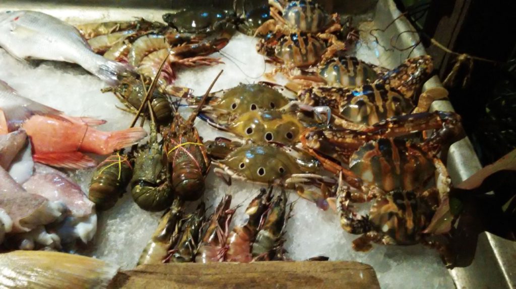 Fresh seafood options outside restaurants in Varkala
