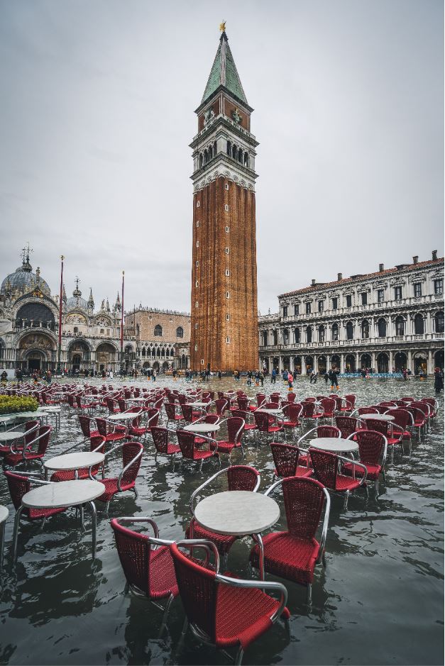 empty restaurant seats and tables during the high tide (acqua alta) in Venice, Italy on St Mark’s Square