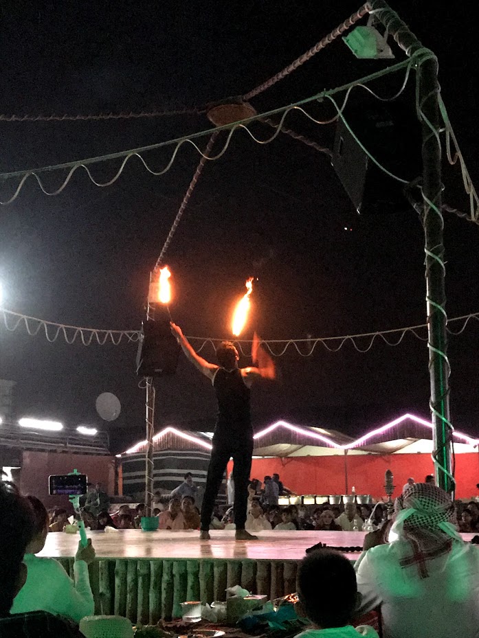 A man performing a Fire show at a bedouin camp during desert safari