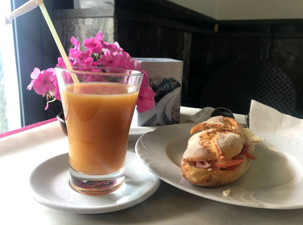 Fresh peach juice with a sandwich for breakfast in Amalfi coast