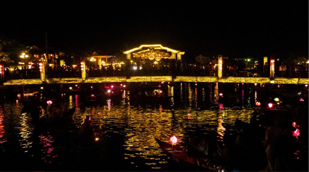 Bridge lit up at night over the canal in Hoi An, New year eve in Hoi An