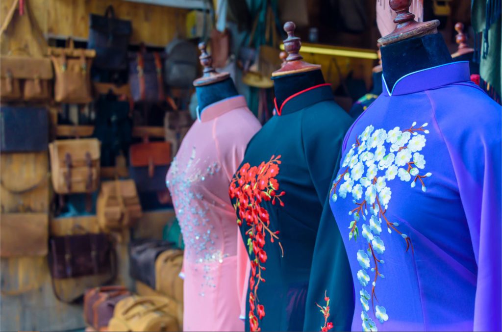 Traditional Vietnamese dresses outside custom tailor shop in Hoi An