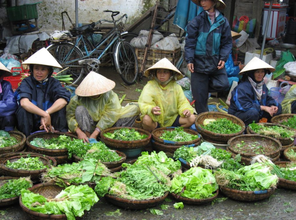 Vendors selling vegetables in Hoi An Central Market