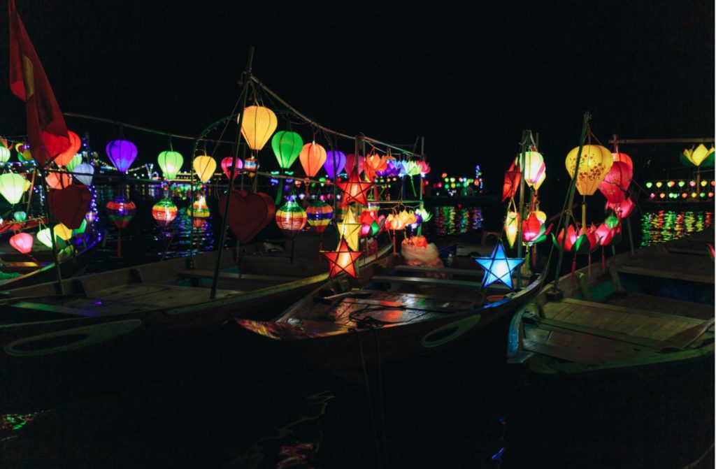 Boats decorated with lanterns for rides at night in Hoi An