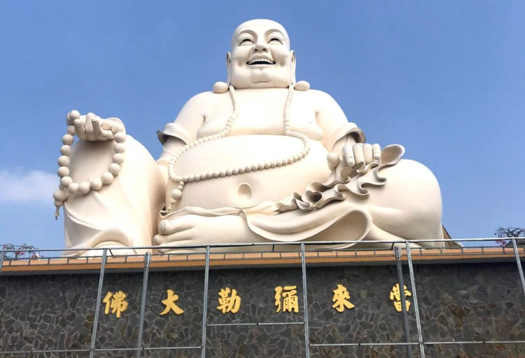 A large statue of Laughing Buddha signifying Luck and Happiness