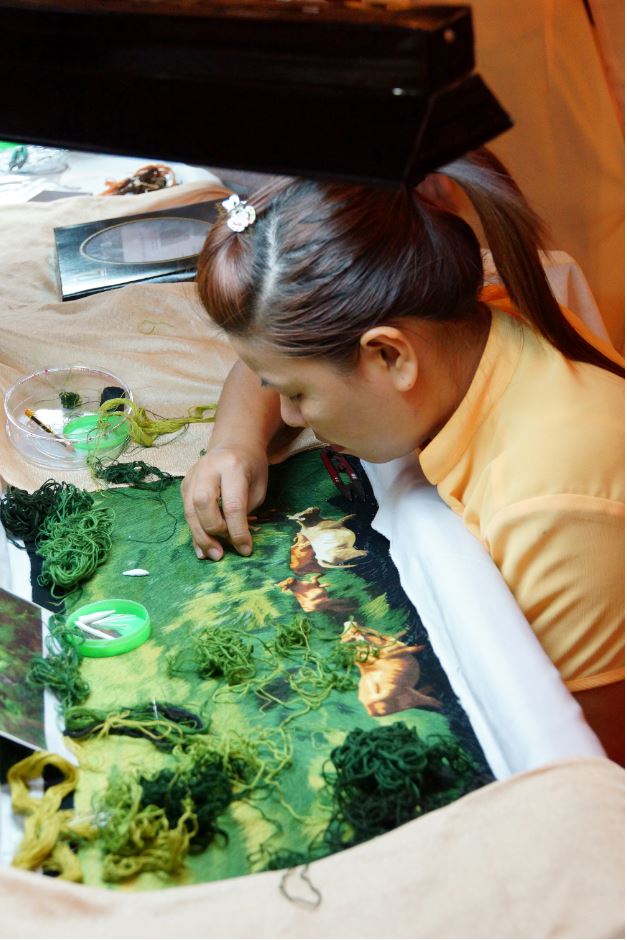 Artist working on traditional Vietnamese embroidery