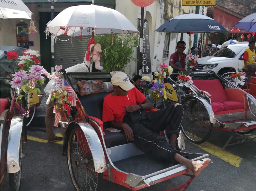 A trishaw driver napping in the afternoon