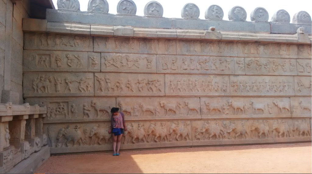 Stone wall with Dasara procession Hampi