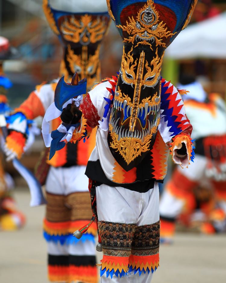 Local men performing in costumes in Phi Ta Khon, Festival in thailand