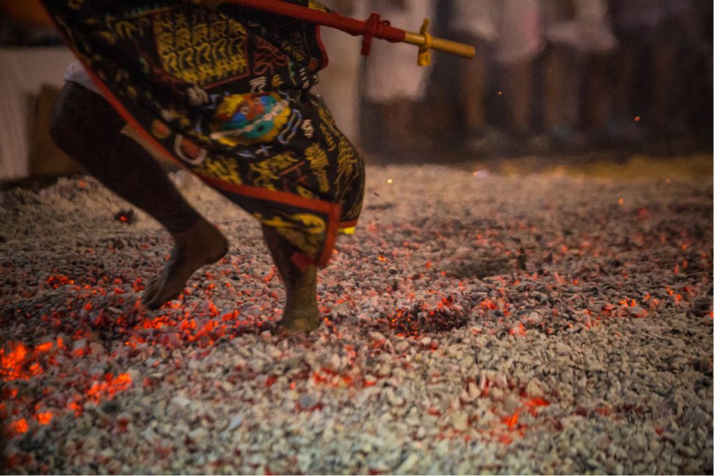 People walking on glowing embers