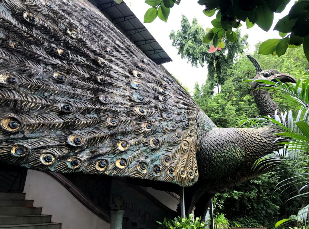 A sculpture of a large peacock