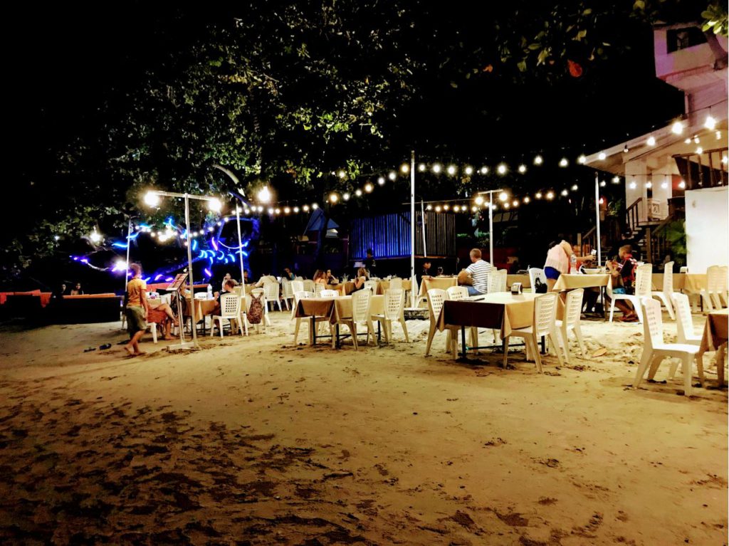 Seaside restaurants at night on White Sand Beach