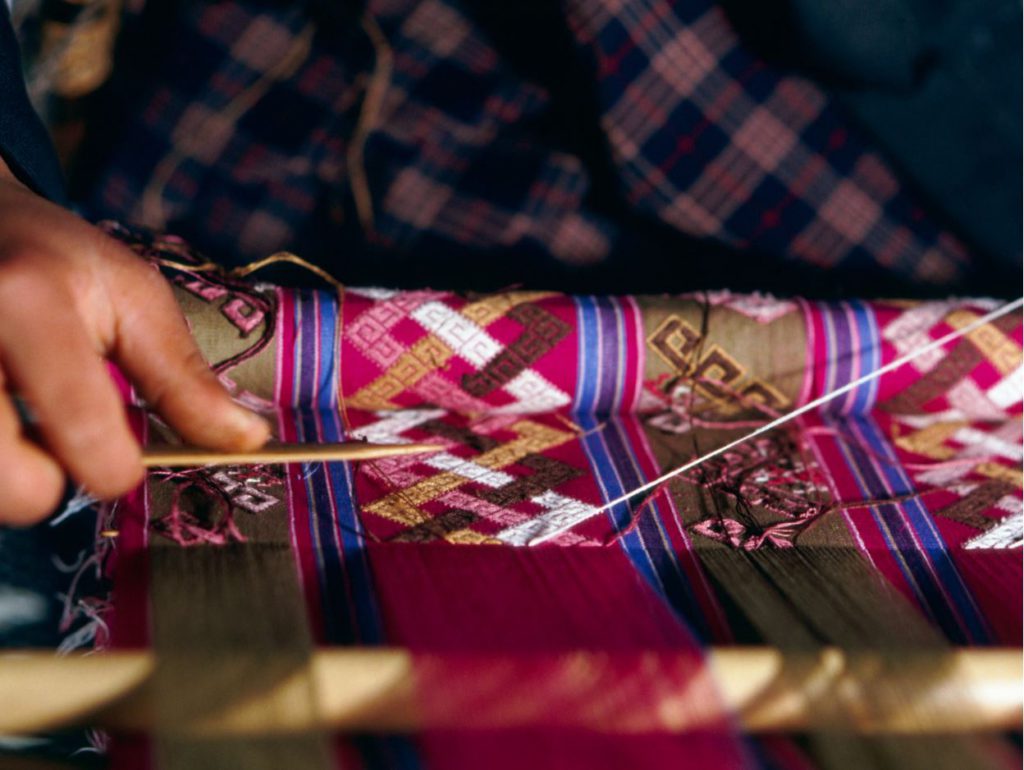 A woman weaving a traditional pattern in Bhutan