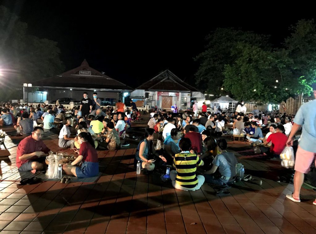 People seated to eat at the Night market inside Wat Phumin premises