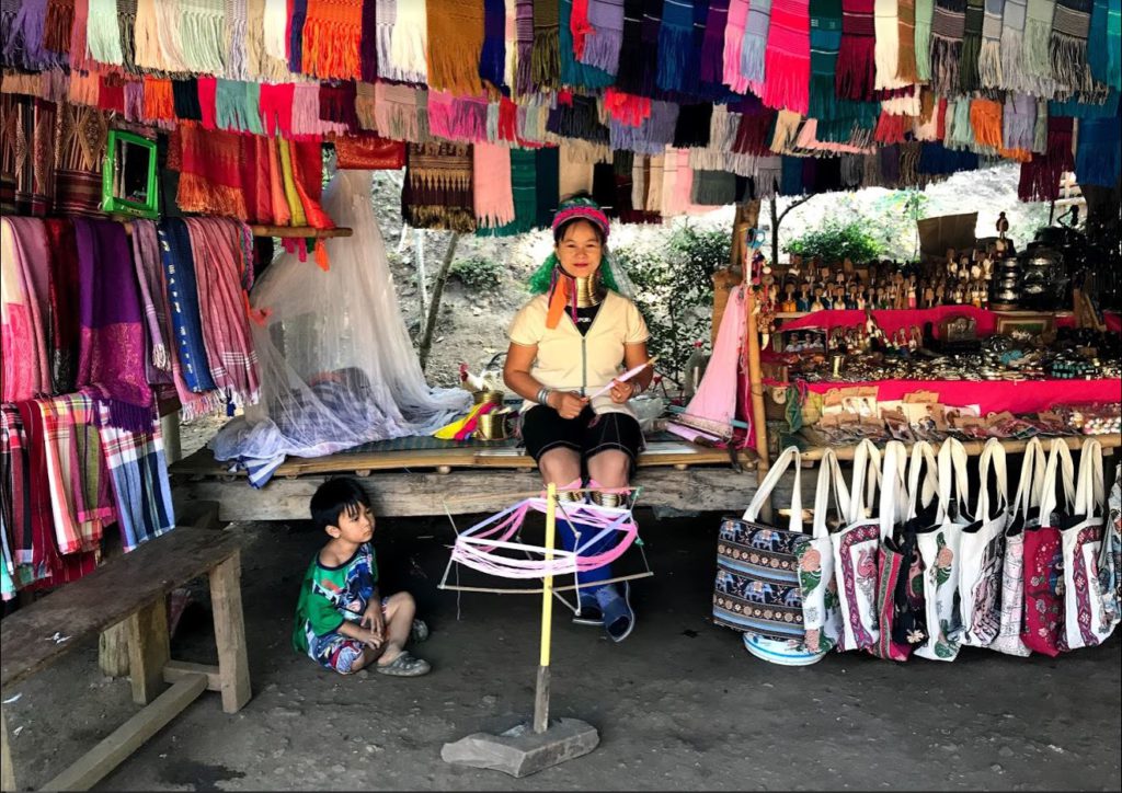 A woman with her child inside the long neck tribe village, Thailand