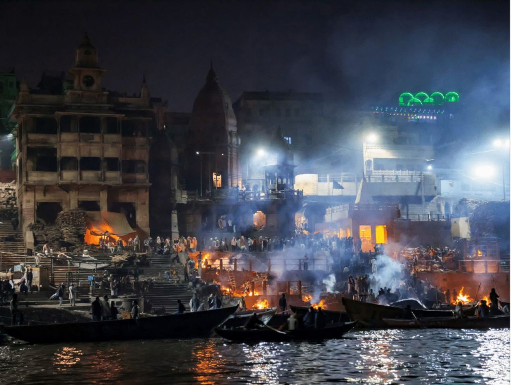 Manikarnika Ghat at night with burning pyres, varanasi