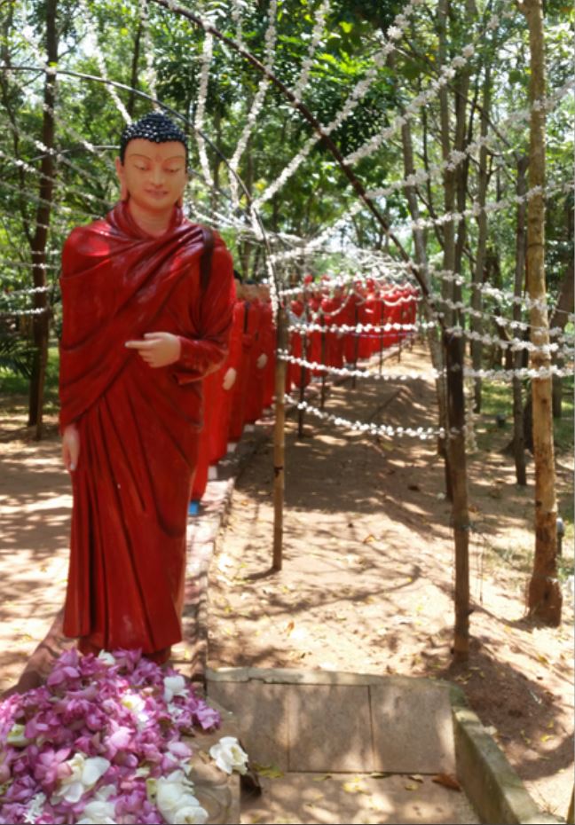 Statue of Monks in Orange robes in Nellikulama temple, Anuradhapura