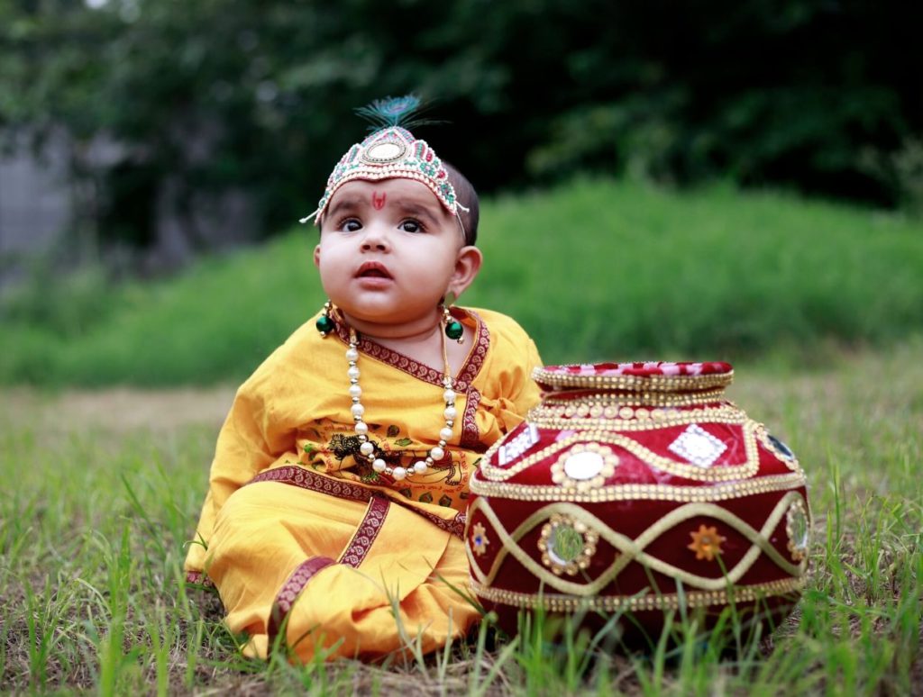 A baby dressed up as Lord Krishna on Janmashtami