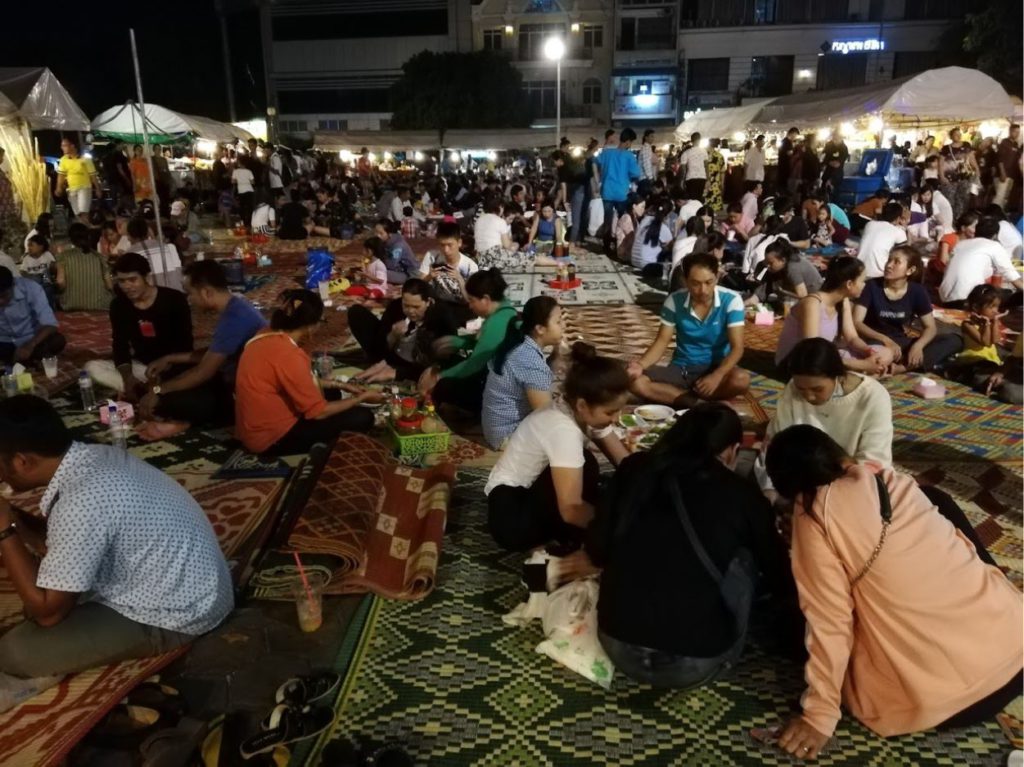 Local night market where locals sit on floor mats to eat in Phnom Penh