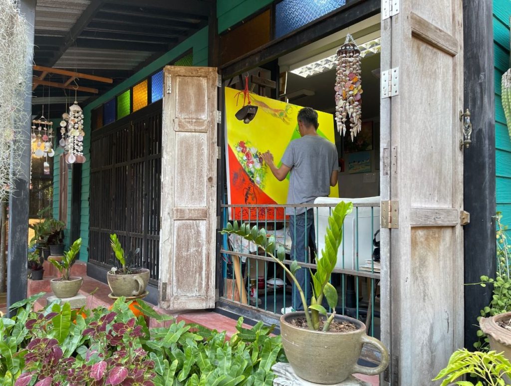 An artist painting at the Artists Village