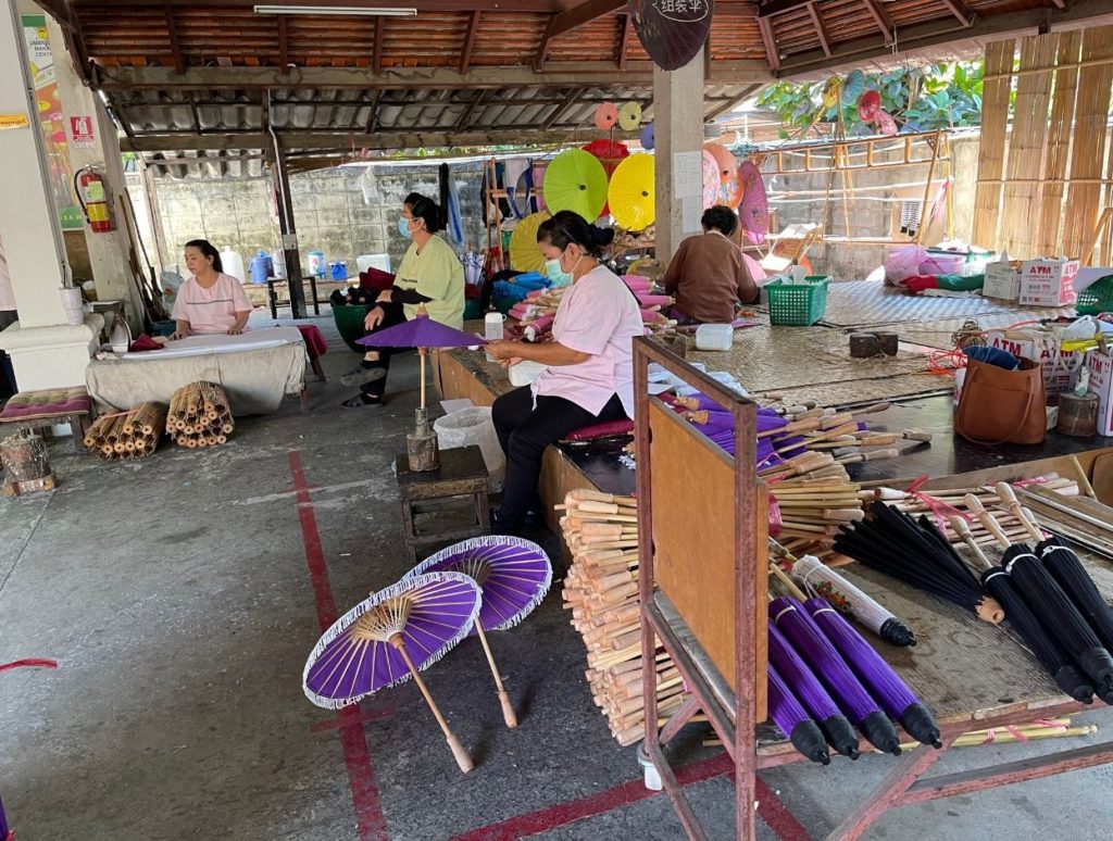 Locals making paper umbrellas