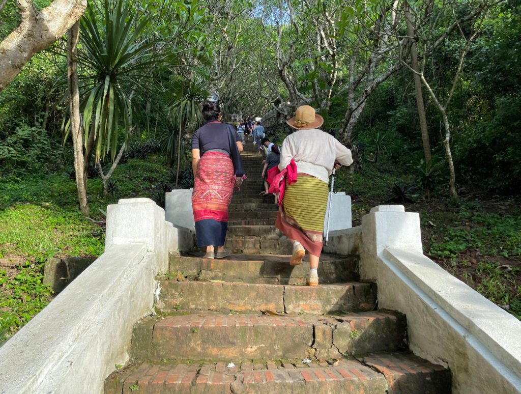 People walking up to Phousi Hill