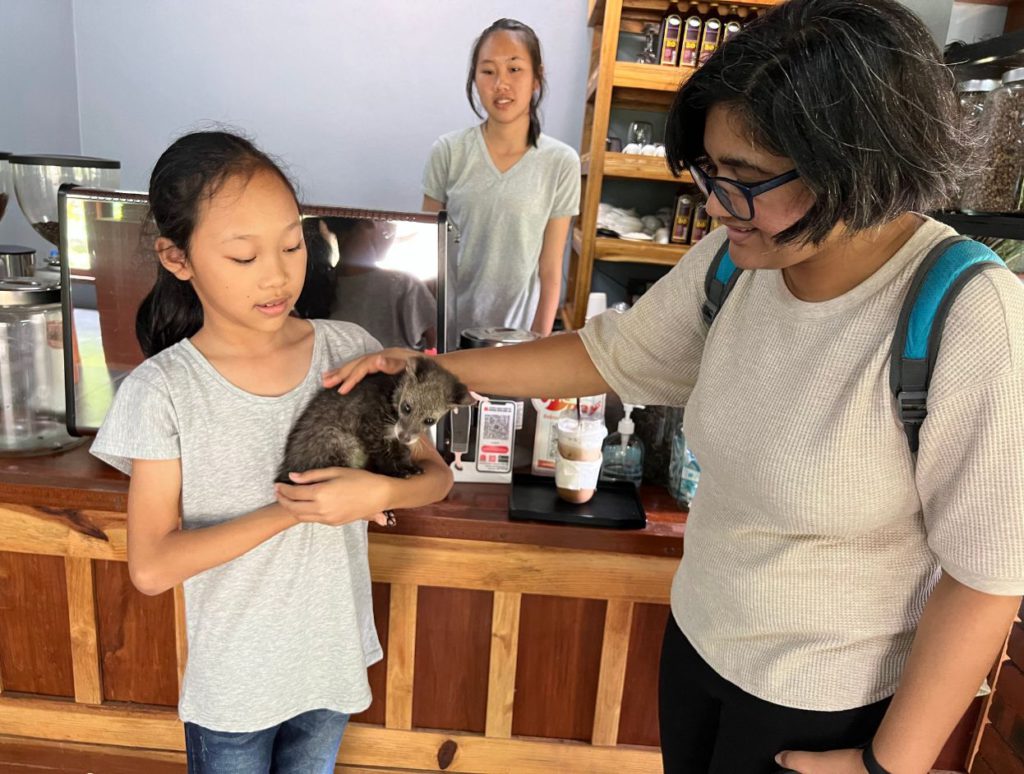 Petting their pet civet cat