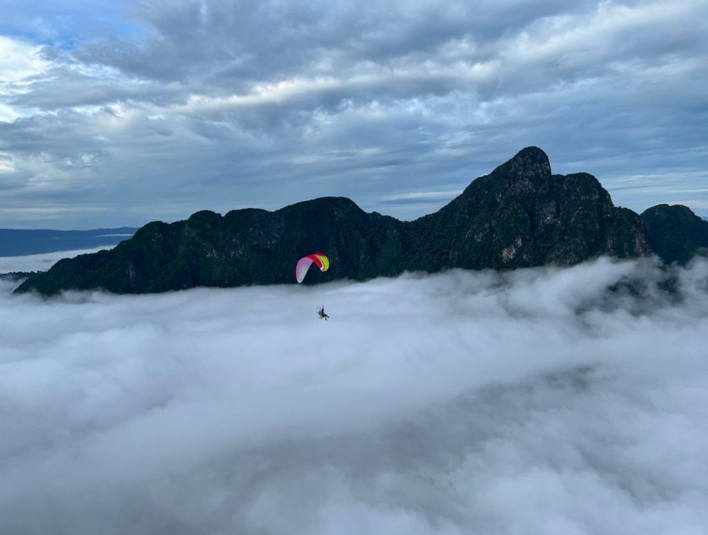 spot the paraglider above the clouds