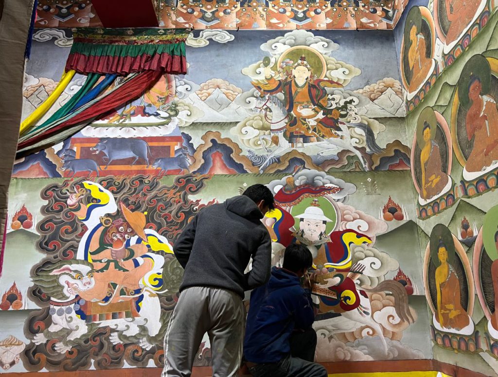 Students repainting the murals inside the monastery