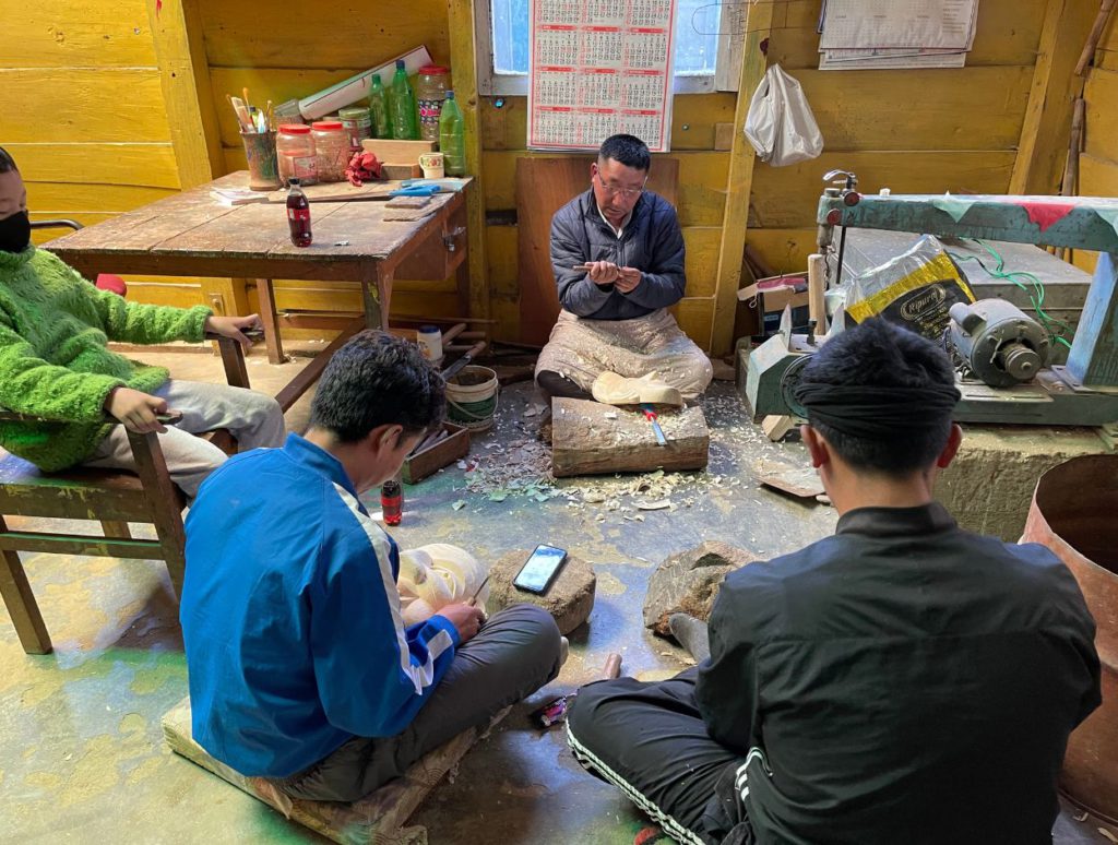 Workers making wooden masks