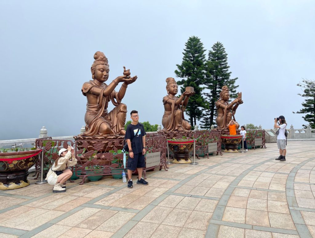 Statue of six devas (gods) offering flower, incense fruit etc to the Buddha